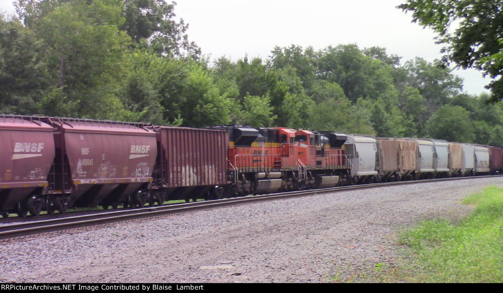 BNSF units sandwiched by cars